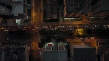 City nighttime drone shot over street congested with car traffic; Quito	