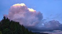 Cumulative clouds forming over the landscape sunset timelapse