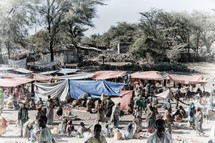 tents and people at an outdoor market 