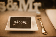 groom place card on a table 