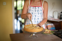 woman cutting a pie 