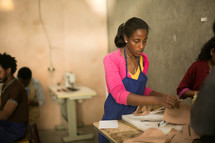 woman working in a leather cutting shop 