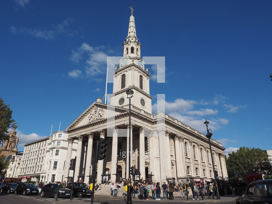 LONDON, UK - SEPTEMBER 27, 2015: Tourists in Trafalgar Square in front of St Martin in the Fields church