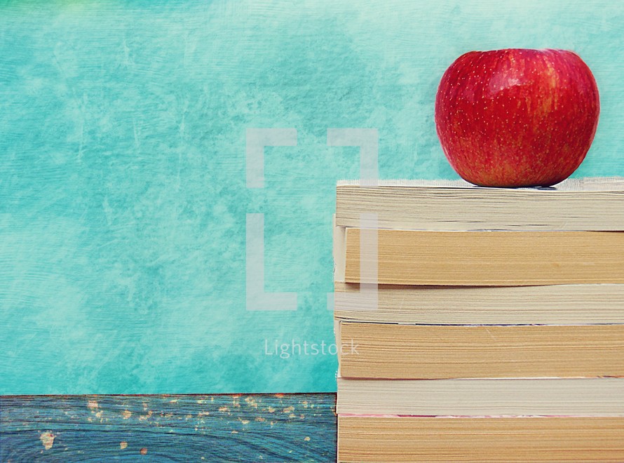 an apple on a stack of books 