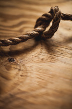 Knot in rope on wood.
