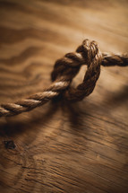 Knot in rope on wood.