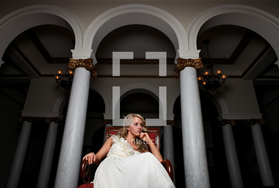 bride sitting in a red chair 