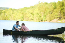 A couple talking in a canoe