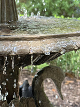 garden fountain closeup with dripping water