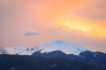 Snow capped mountain peak during sunset 