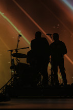 silhouette of a band on stage