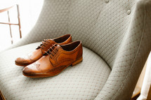 men's dress shoes on a chair 