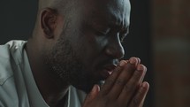 Close-Up of African American Man Praying with Hands Together