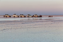 vehicles on a salt lake shore in Ethiopia 
