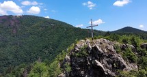 Wooden cross on top of a mountain in Romania.
