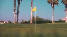 Golf course flag, summer tropical golf resort, green hole tee links course