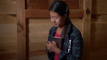 Devoted Young Woman Praying with Bible