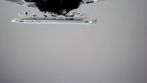 Smartphone falling into water - close up - slow motion