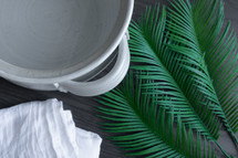 clay vessel of water and palm fronds 