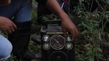 People Tuning And Listening To Radio In Asian Jungle