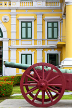 old cannon, and yellow building, in Bangkok