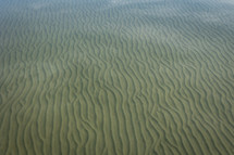  ripples and reflections of sand in the bottom of the lake