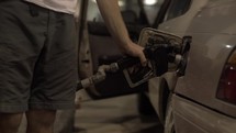 4K Slider Shot Pumping Gas Into Car Putting Away Fuel Nozzle