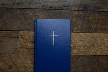 cover of a Bible on wood 