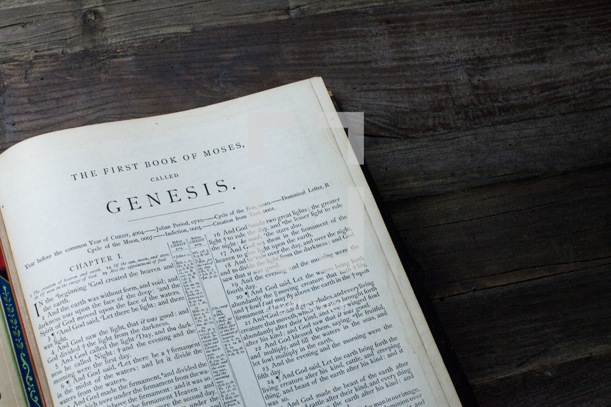 A Bible open to the book of Genesis.