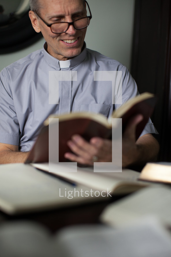 A minister reading the Bible and preparing a sermon.