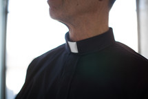 A minister wearing a clerical collar.