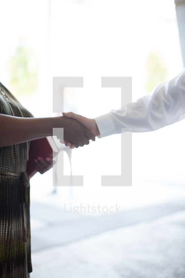 handshake in a church narthex 