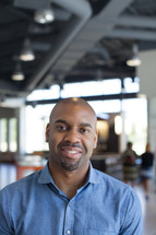 headshot of a man standing in the Harvest Church lobby  