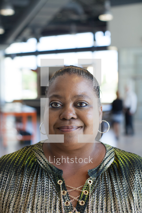 headshot of an African American woman standing in the Harvest church building lobby 