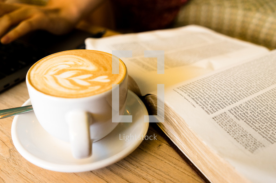 heart shaped creamer in a latte and open Bible 