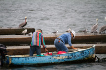 pelicans and fishermen on a boat 