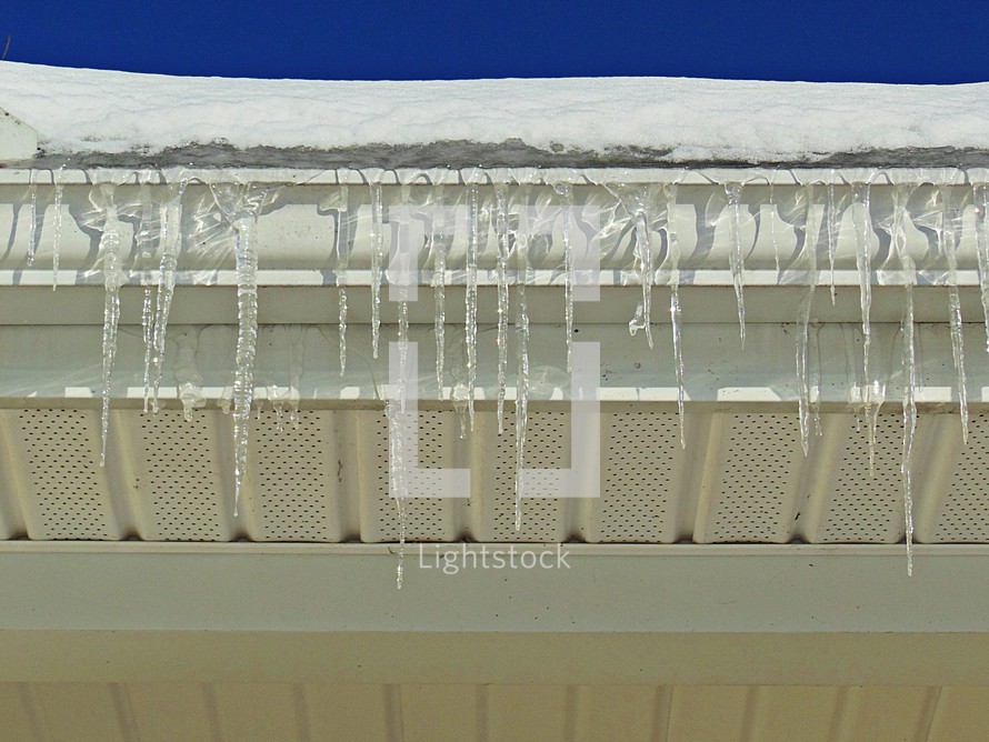Icicles hanging off a gutter. 
