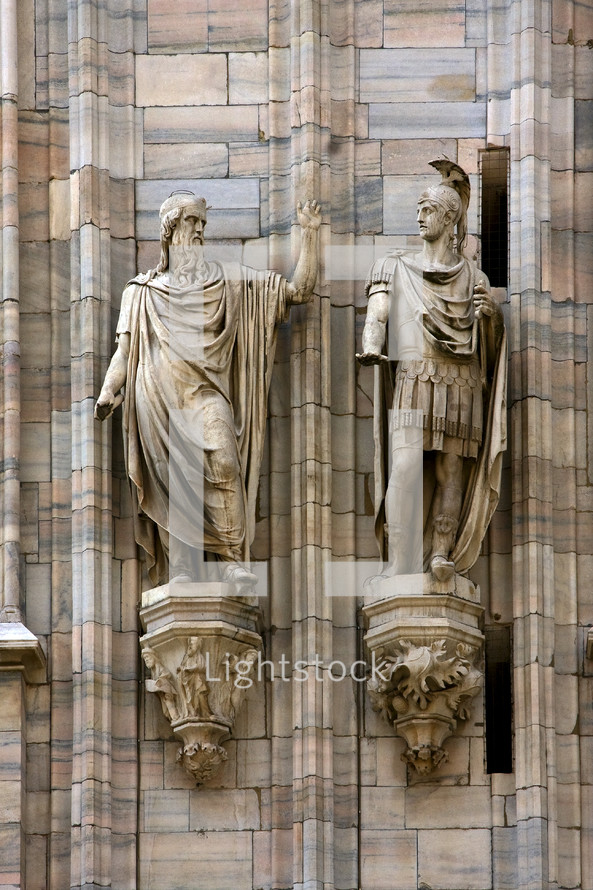 two statues on exterior of a church 