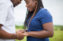 happy African-American couple holding hands outdoors 