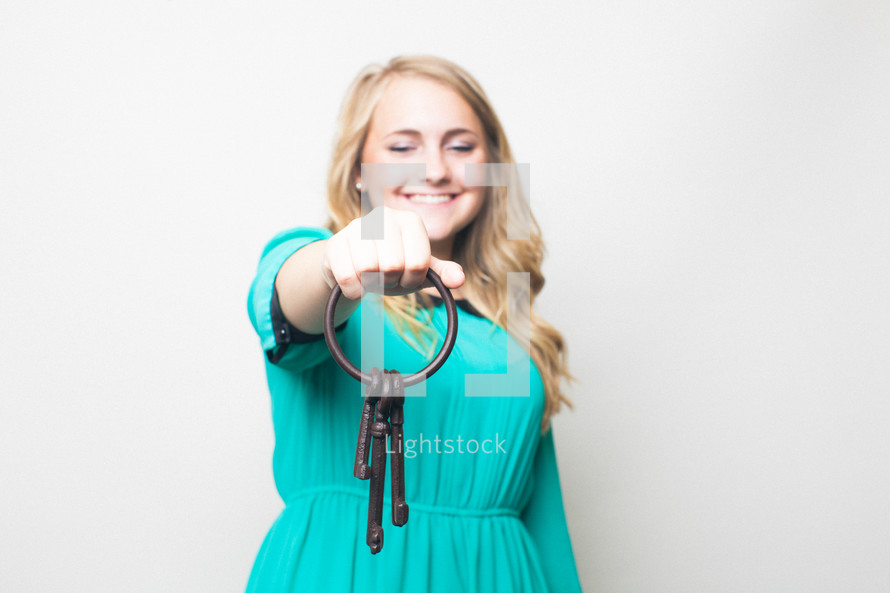 woman holding a key ring
