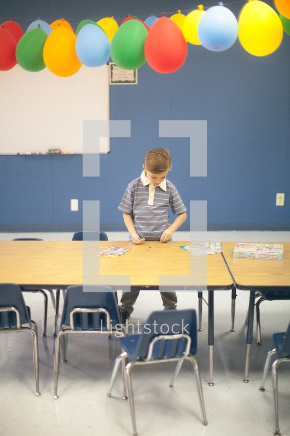 balloons in a classroom and boy child 