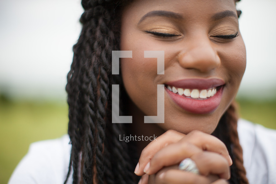 African-American woman in reverent prayer 