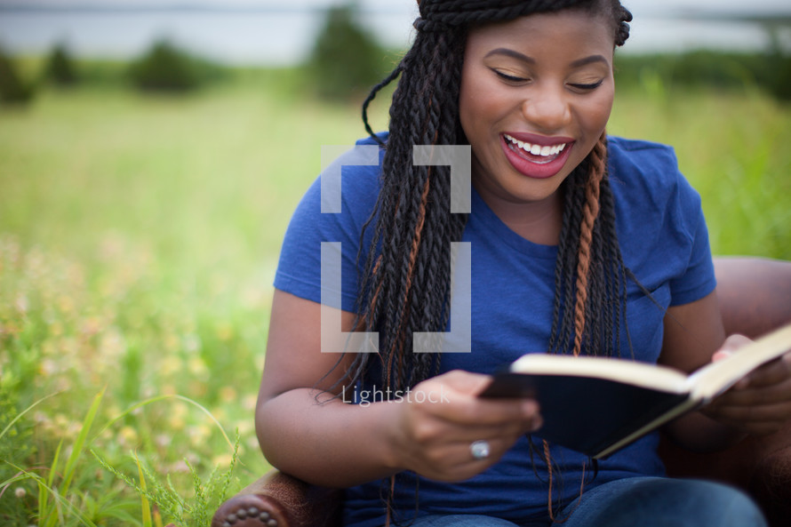 happy woman reading a Bible 