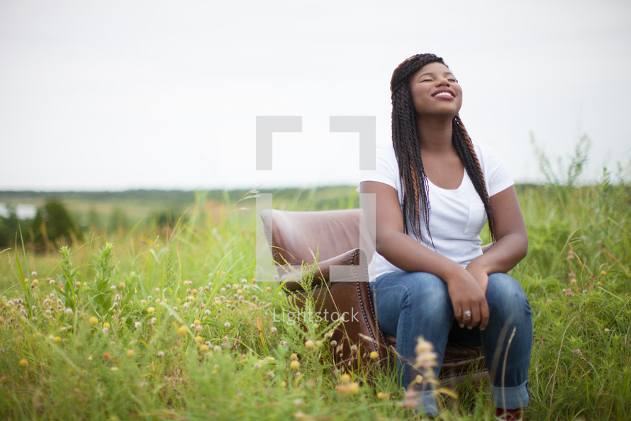 woman with face turned to God sitting outdoors 