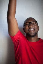 african-american man with hand raised to God 