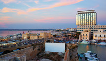 Panoramic view of Gallipoli harbour, ancient and modern buildings on the Ionian sea. Salento, Apulia, Italy