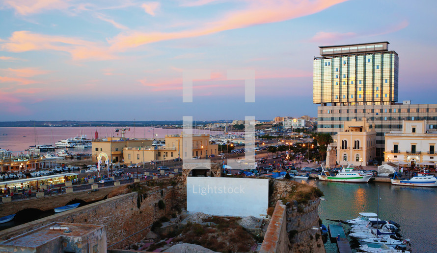 Panoramic view of Gallipoli harbour, ancient and modern buildings on the Ionian sea. Salento, Apulia, Italy