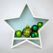 green Christmas ornaments in a star 