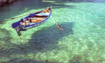 row boat on turquoise water 