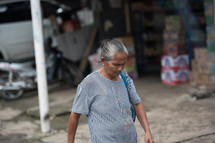 woman walking on a dirt street in Indonesia 